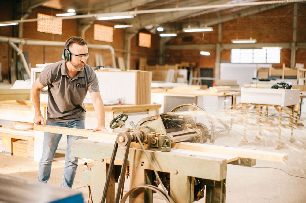 A craftsman working at a machine in a woodworking workshop